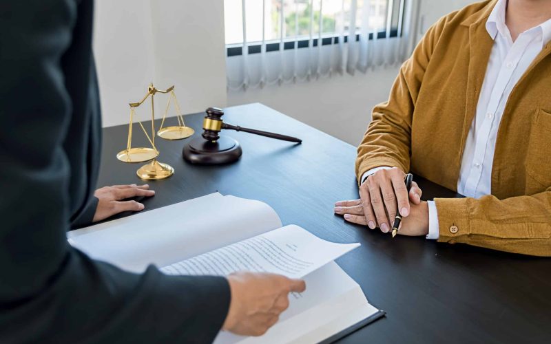 Judge gavel with Justice lawyers having team meeting at law fir Judge gavel with Justice lawyers having team meeting at law firm background. Concepts of Law and Legal services.